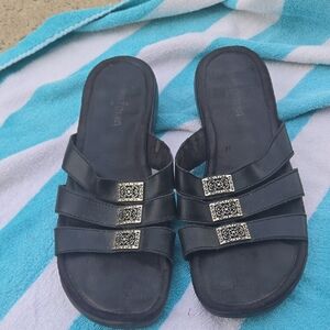 Minnetonka Black Slide Sandals with Silver Accents